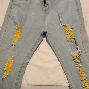 Stylish Distressed Light Blue Jeans with Yellow Accents